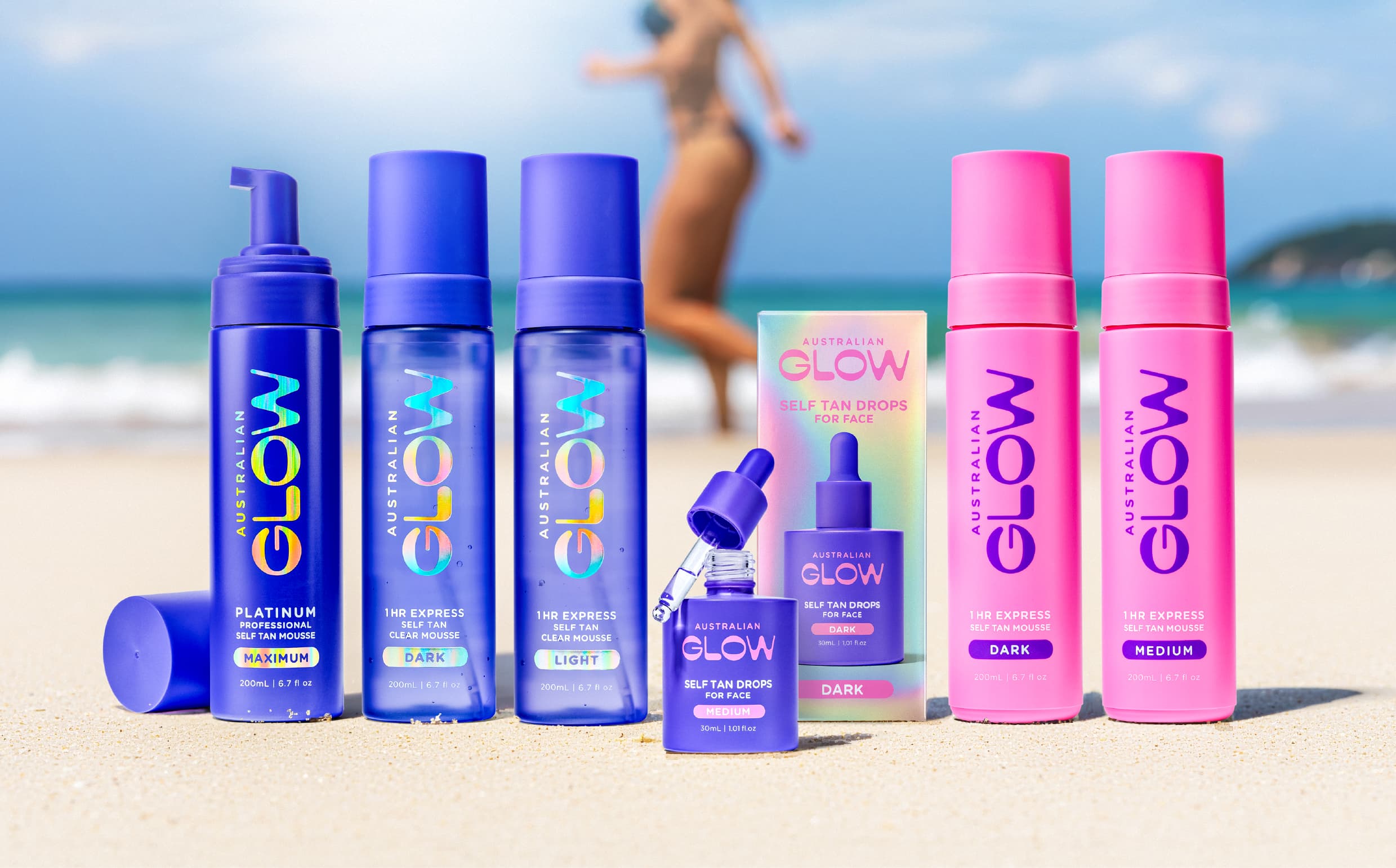 Big Glow lineup on the sand — the full Australian Glow range against ocean horizon